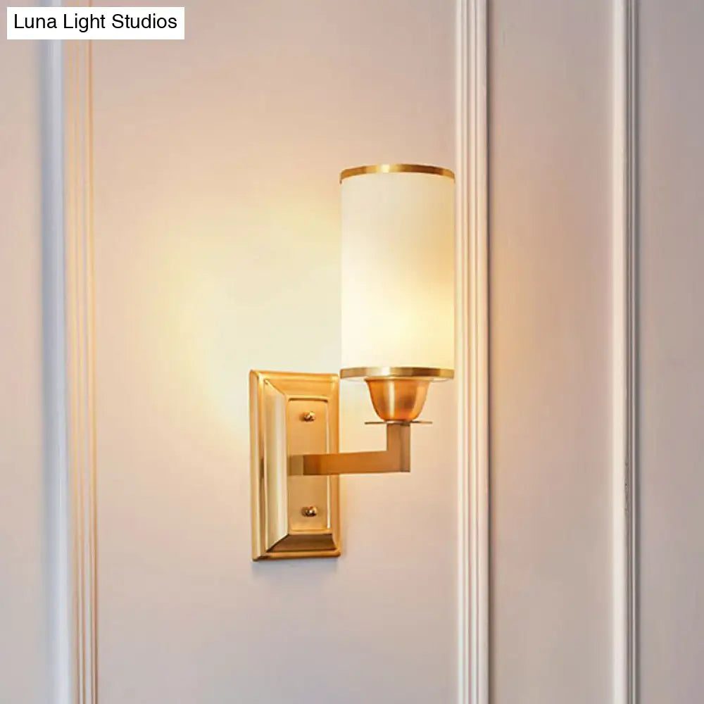 1-Light White Glass Wall Sconce in Traditional Brass - Elegant Cylindrical Dining Room Light
