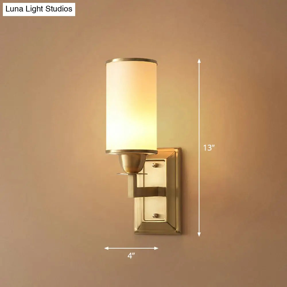 1-Light White Glass Wall Sconce in Traditional Brass - Elegant Cylindrical Dining Room Light
