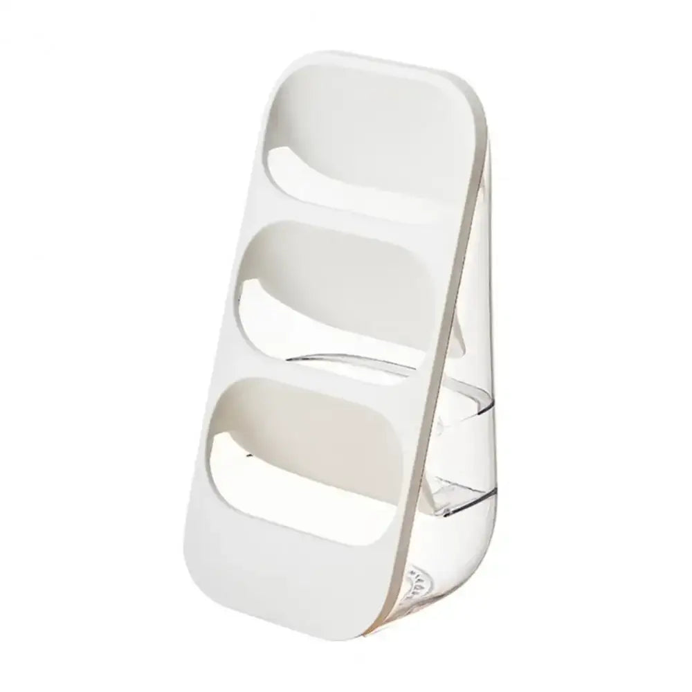 White plastic three tiered spice rack serving as a kitchen utensil organizer and cutlery rack for countertop use