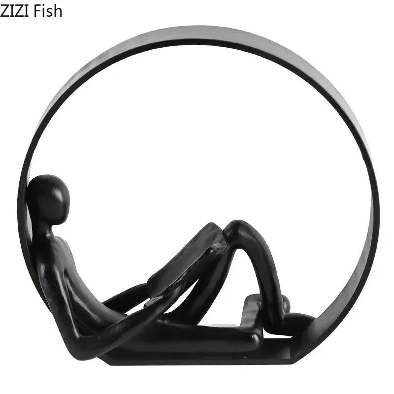 Black glossy resin sculpture of a minimalist abstract resin character reclining in a circular frame for home decor