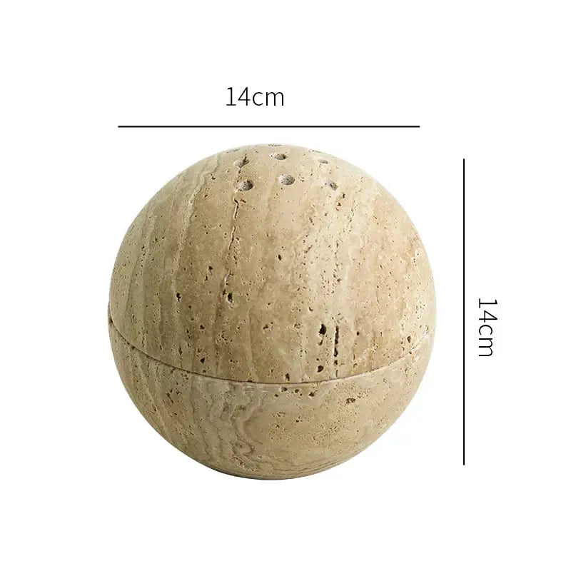 Beige travertine marble sphere incense burner with textured surface and perforations for living room decor by decorbites