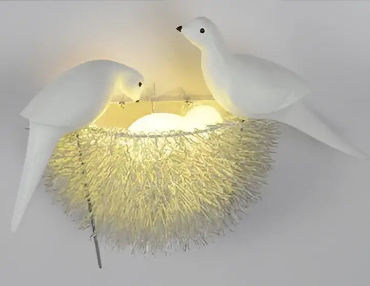 White ceramic dove led wall lamp featuring a glowing golden metallic filament nest for bedroom sconce lighting