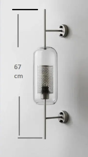 A decorbites chiswick glass wall light sconce with a clear glass cylinder and metallic mesh interior for home décor