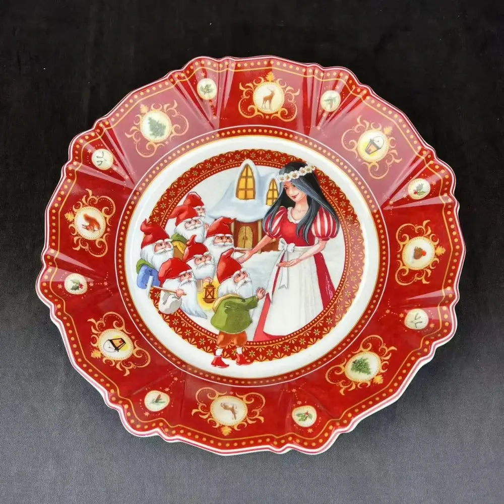 A red and gold decorative plate with snow white and the seven dwarfs illustration from decorbites christmas tableware set