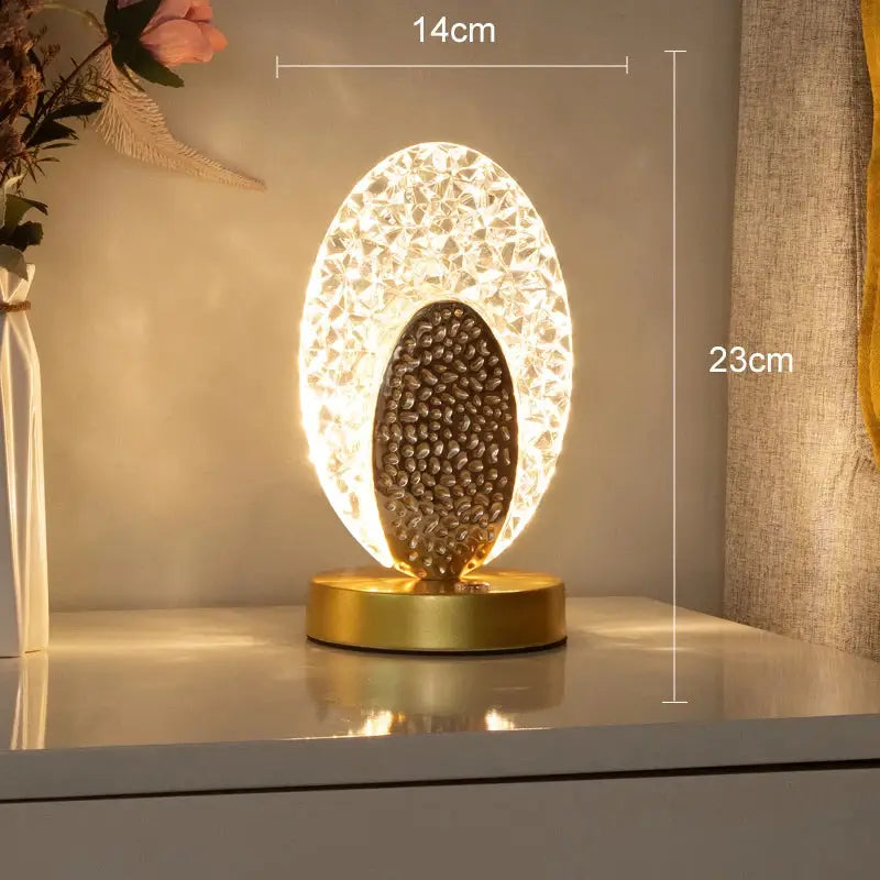 Gold-toned decorbites crystal led table lamp with textured illuminated shell and dark pebble design for bedroom décor