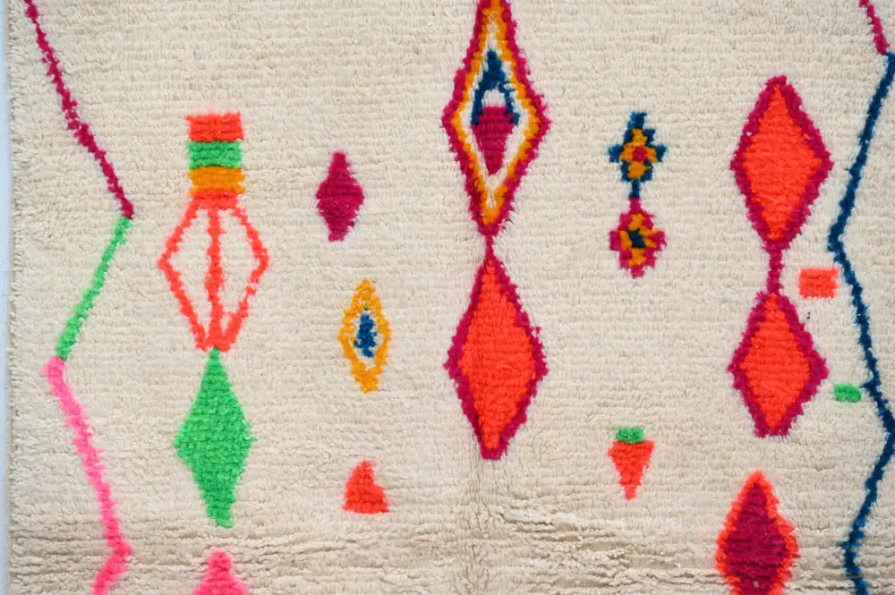 Vibrant geometric-patterned cream wool moroccan azilal rug with bold orange green pink and blue diamond motifs 246 x 146 cm