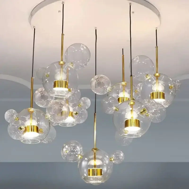 Modern glass bubble pendant lights with gold metal accents and hanging bulbs from DecorBites led glass ball collection