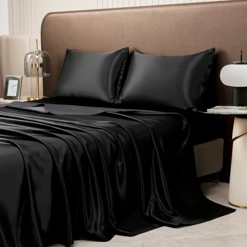 Black satin bedding set with a smooth glossy finish featuring a solid color flat sheet by DecorBites™ Luxurious