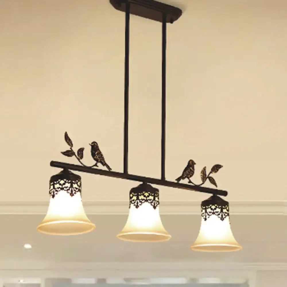 Black wrought iron DecorBites™ pendant light with three handblown glass shades and decorative bird details for dining room