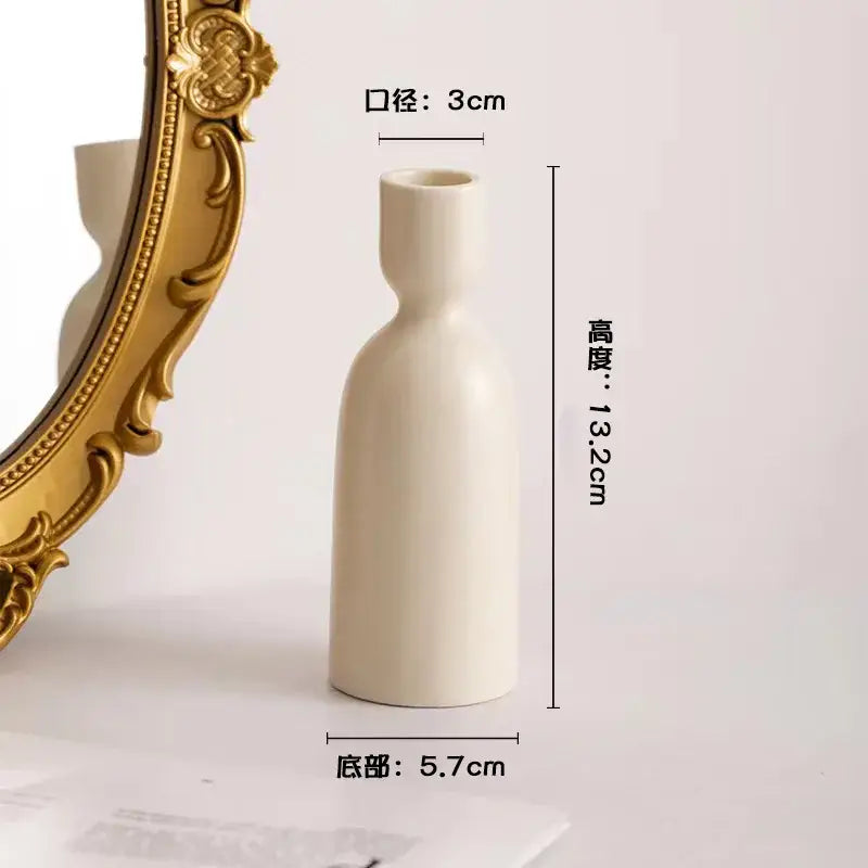 Cream-colored geometric ceramic candle holder with slender bottle-like silhouette and smooth matte finish from decorbites
