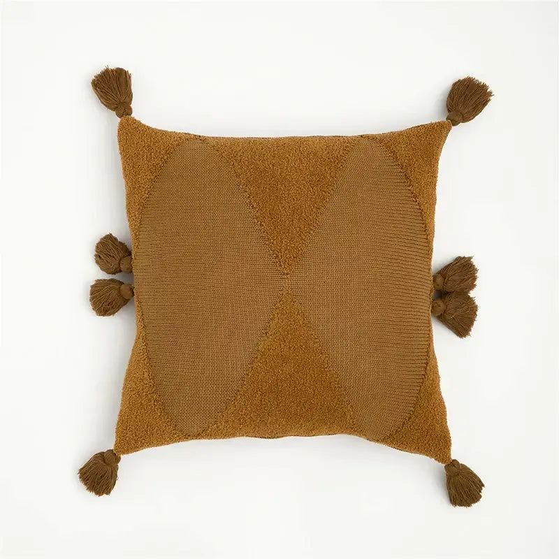 A cozy knitted mustard blue cushion cover with a geometric diamond pattern and tassels for living room decorbites decor