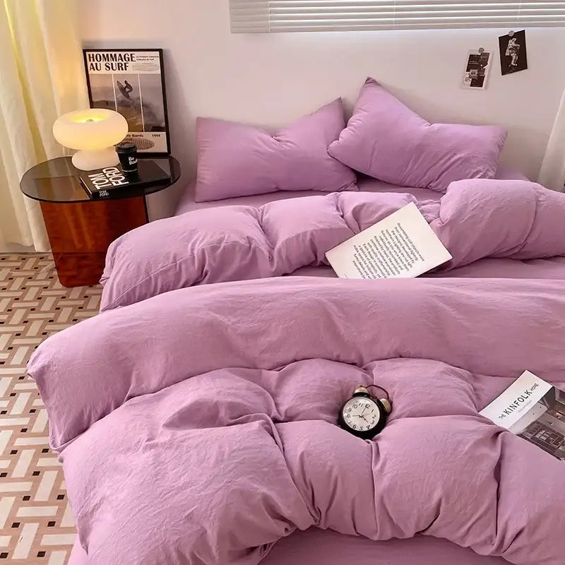 A plush lavender and black cotton bedding set with quilted texture and matching pillows for bedroom comfort
