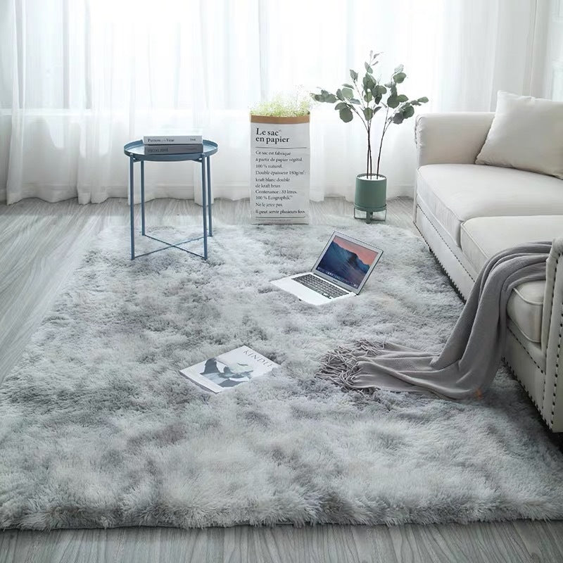 Gray fluffy rug with a textured pattern and soft appearance.