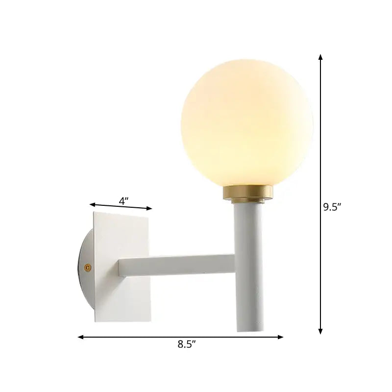 Minimalist white and brass wall lamp with opal glass shade featuring a modern frosted glass globe for bedroom