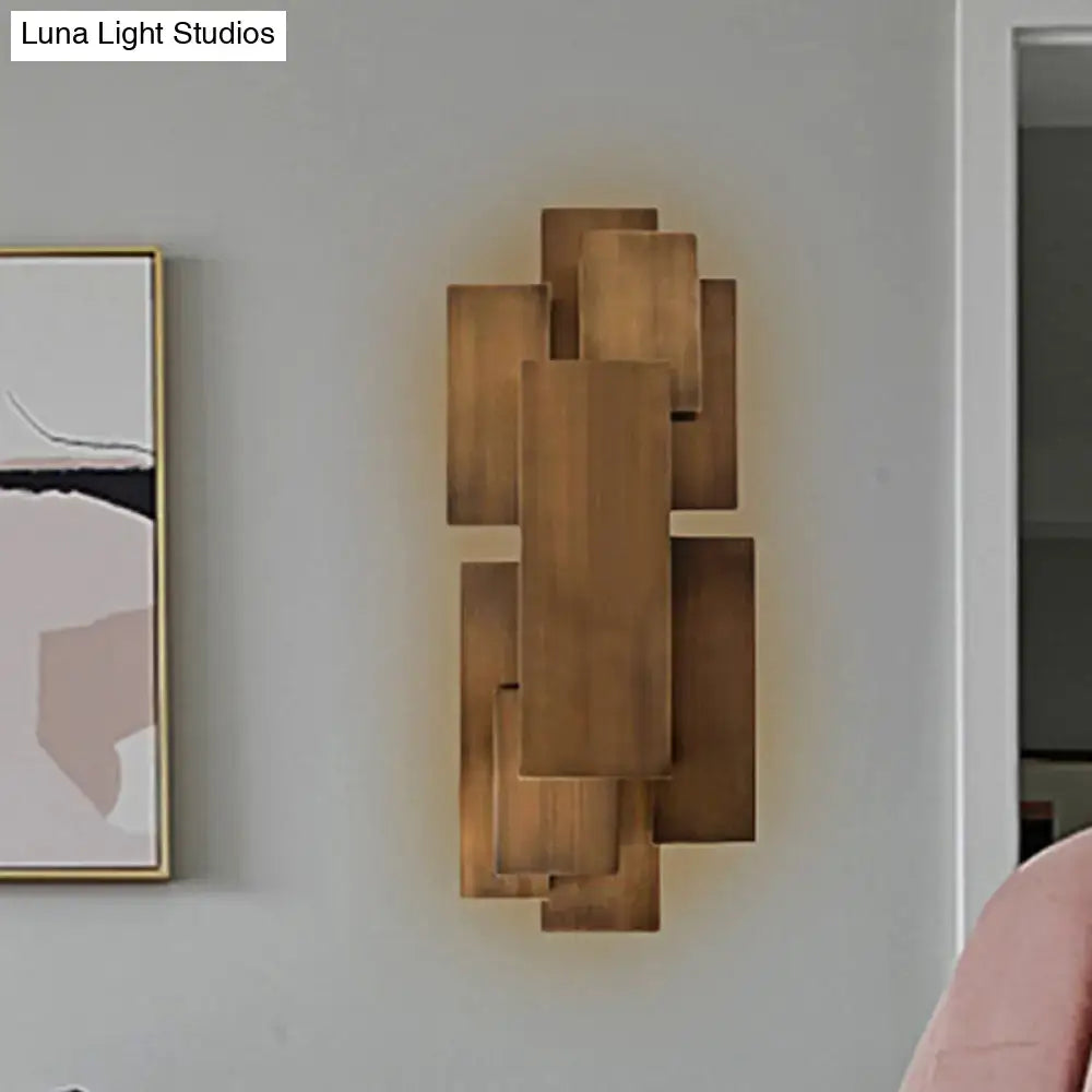 Modern abstract dark wood wall sconce with layered rectangular panels in a geometric pattern direct wired 220v-240v lighting