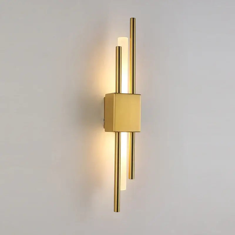 Modern gold acrylic pipe led wall lamp with sleek vertical rods and warm ambient lighting as a bedroom wall sconce
