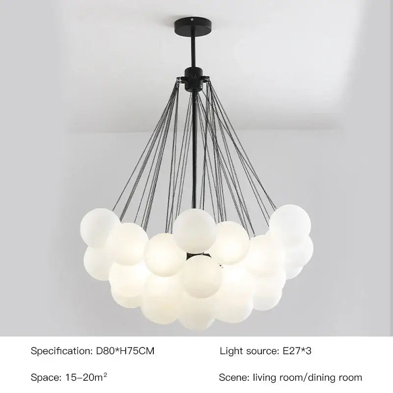 Modern gold and black chandelier with frosted glass ball spheres suspended by thin cables for dining room decorbites frosted glass