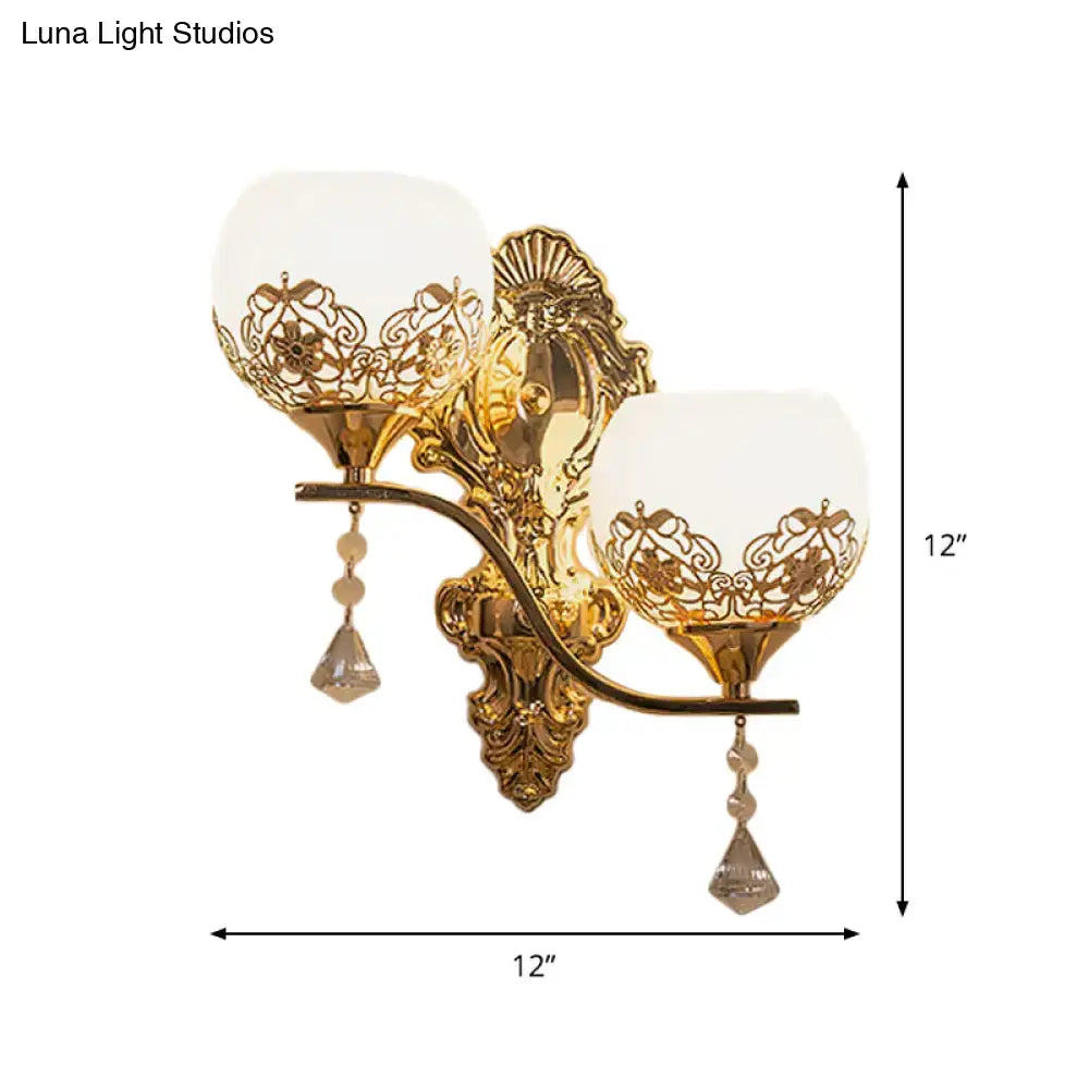 Gold finish modern dome wall sconce with intricate lace metalwork and crystal teardrop pendants for living room use