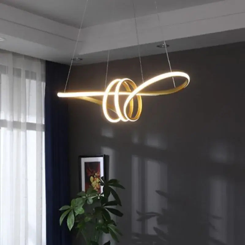 Modern gold infinity cord pendant light featuring a sleek brushed nickel spiral design for dining room illumination