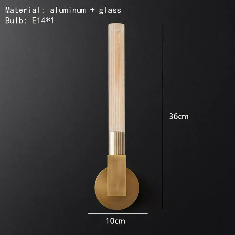 A modern gold metal and glass wall sconce light with brass-finished aluminum base for bathroom use