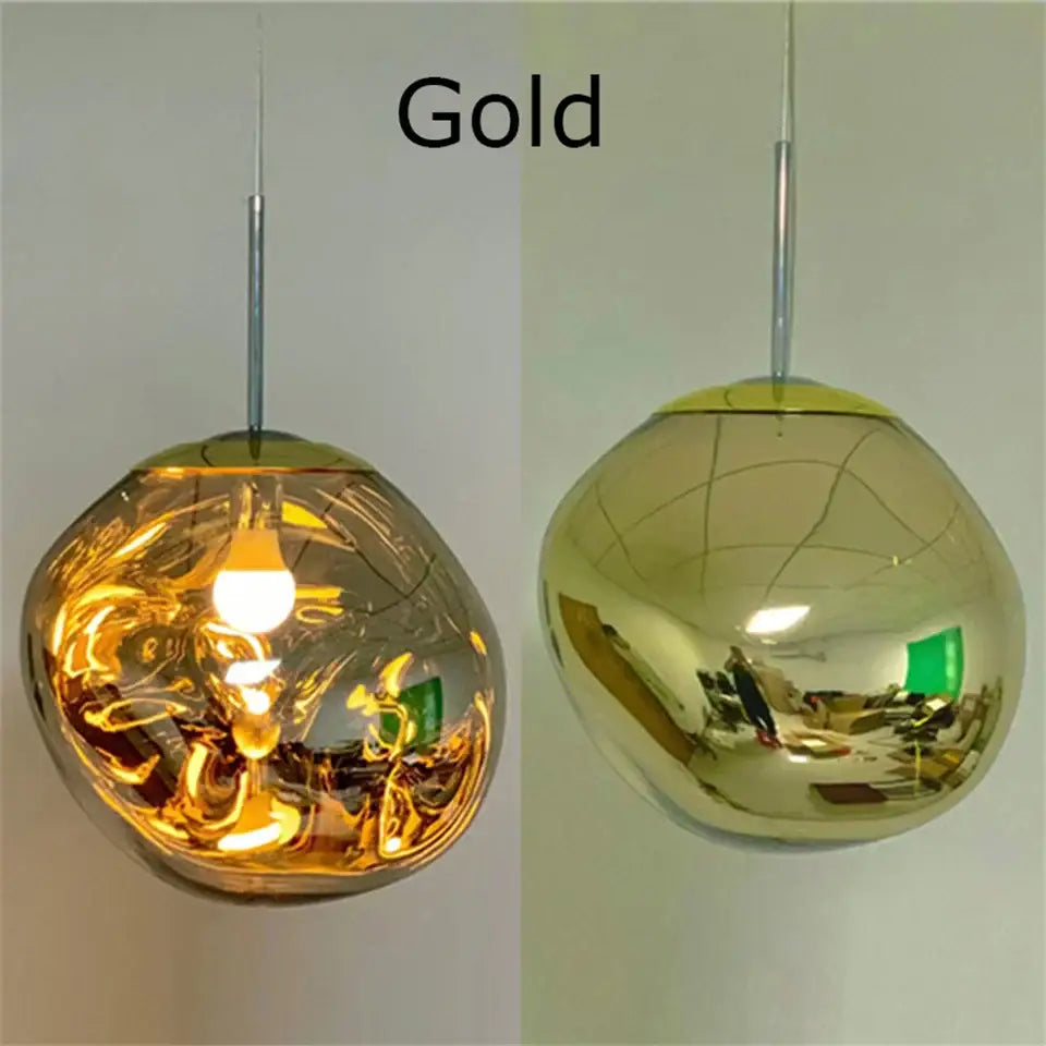 Gold-finished spherical pendant light with organic form and plated finish featuring visible filament bulb for kitchen use