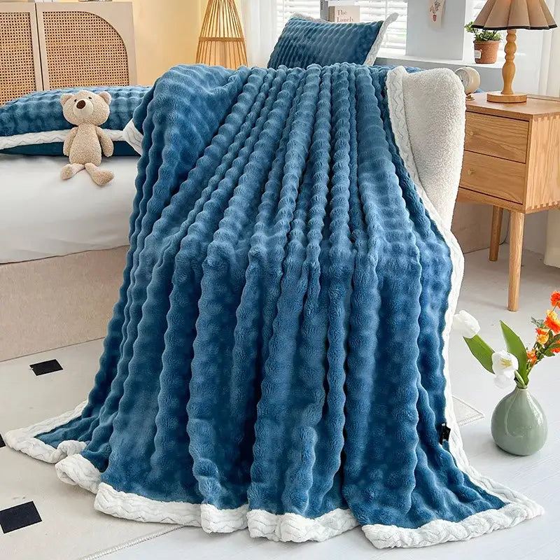 Blue plush throw blanket with textured ribbed surface and white fleece lining from decorbites cozy faux rabbit fur collection