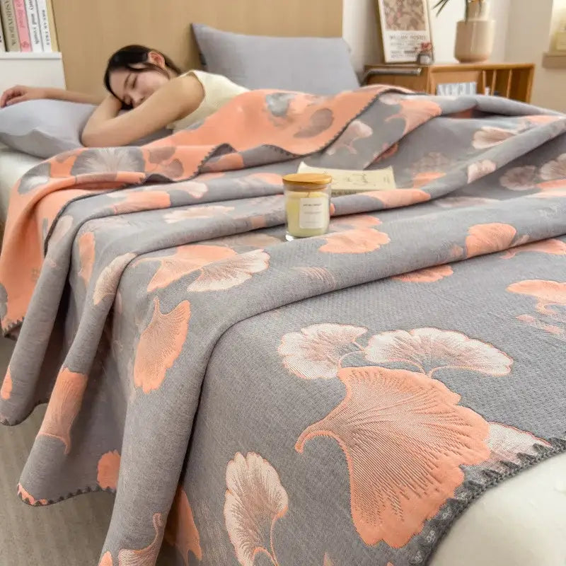 Gray decorbites cotton towel blanket with peach ginkgo leaf patterns made of textured woven fabric for bedroom use