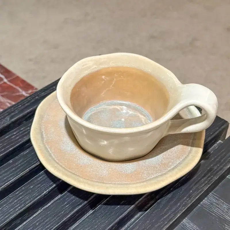 Cream-colored kiln porcelain cup with matching saucer featuring textured glaze and handcrafted decorbites kiln design