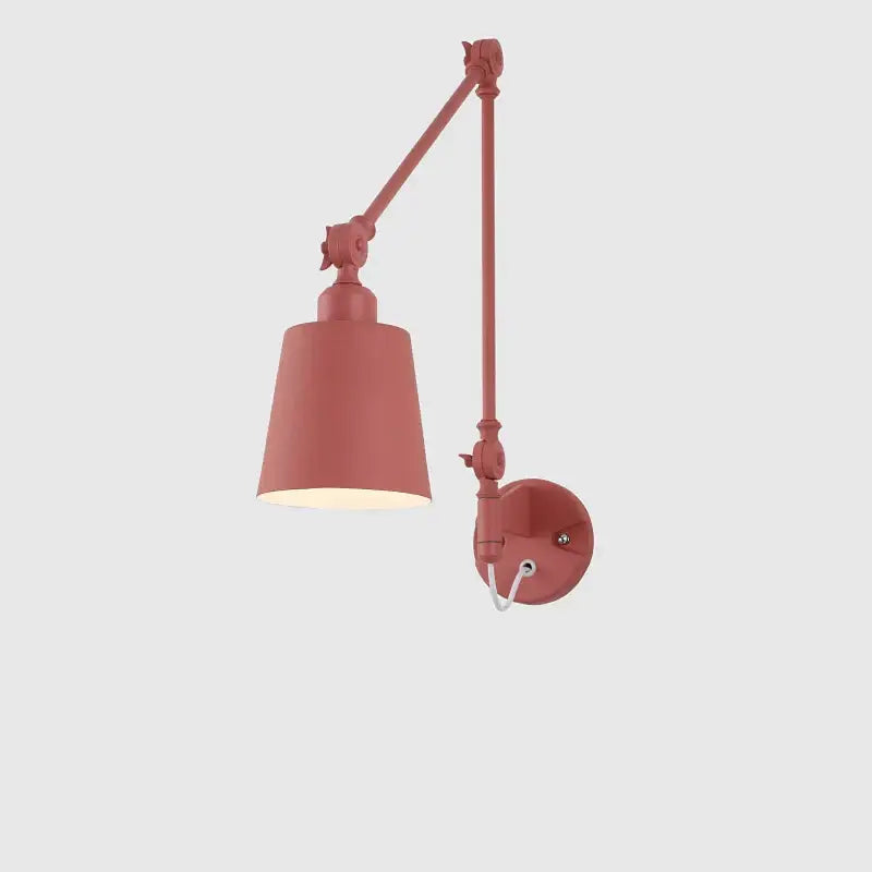 A sleek matte terracotta decorbites adjustable telescopic wall lamp with cylindrical shade and articulated arm for bedroom