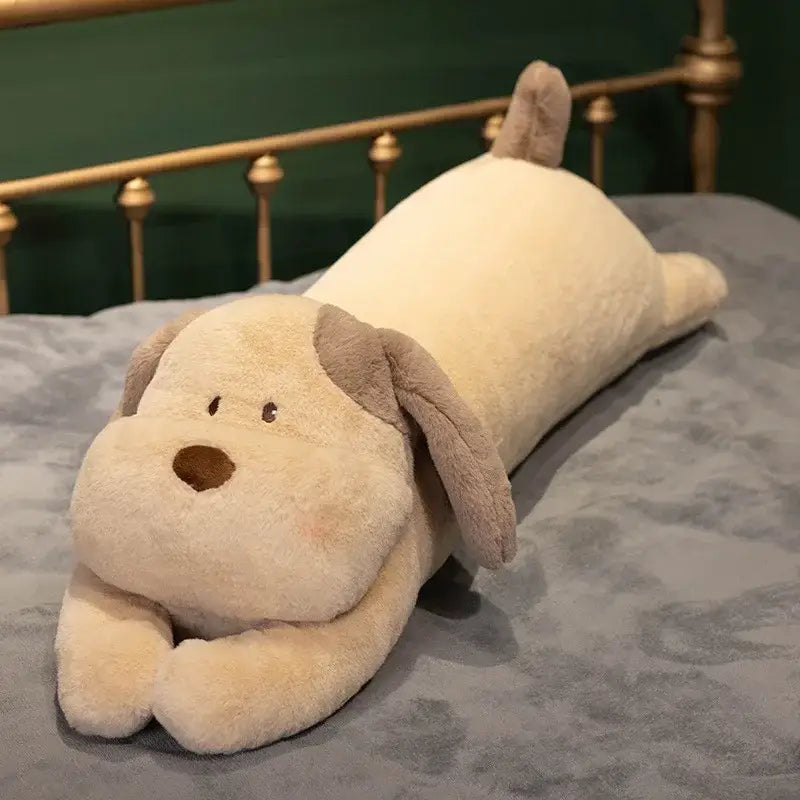A cream-colored plush decorbites dog sleeper body pillow with floppy brown ears for bedroom leg support