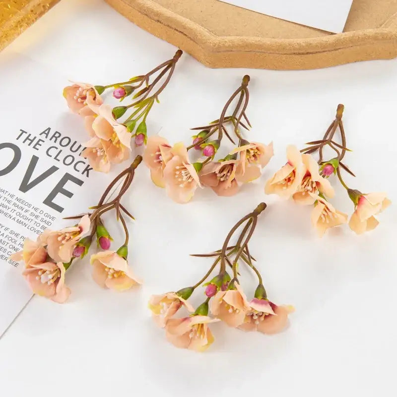 Delicate peach-colored artificial flowers with green stems and buds for living room decor by decorbites artificial flowers