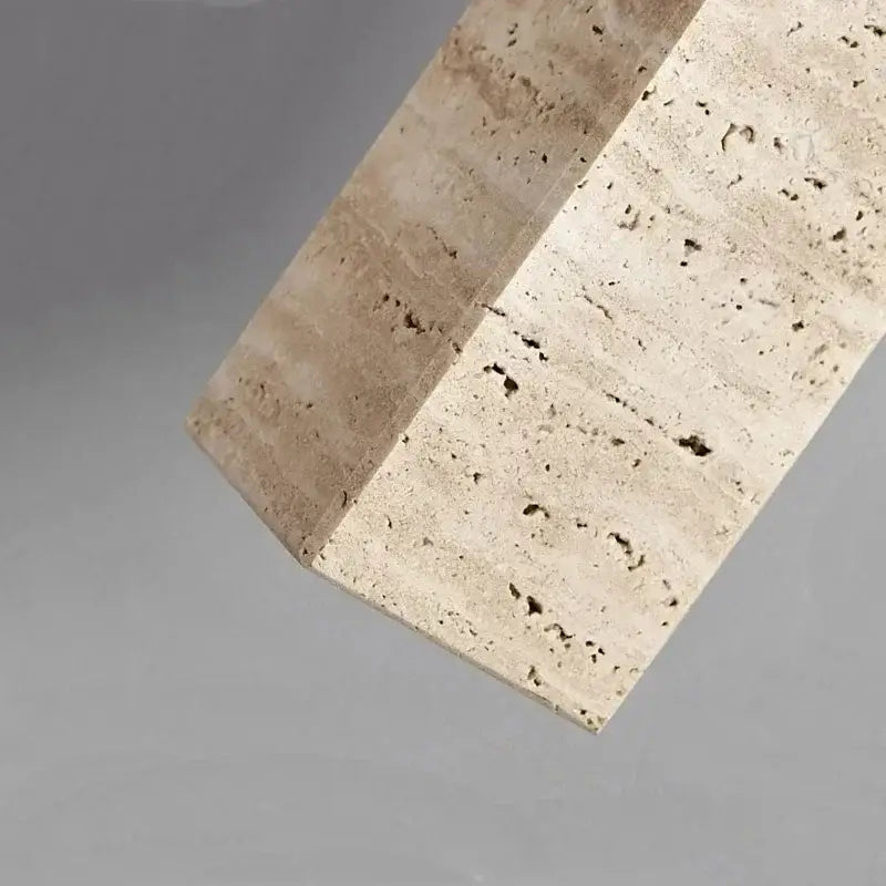 Wabi-sabi yellow marble and brass pendant light with a beige stone block featuring natural texture for modern interiors