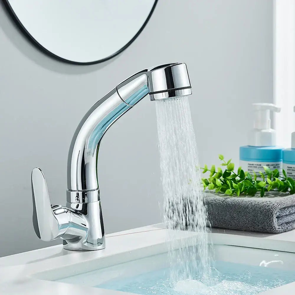 Chrome-finished single-handle bathroom sink faucet with sleek curved spout and pull-down spray head for bathroom sink use