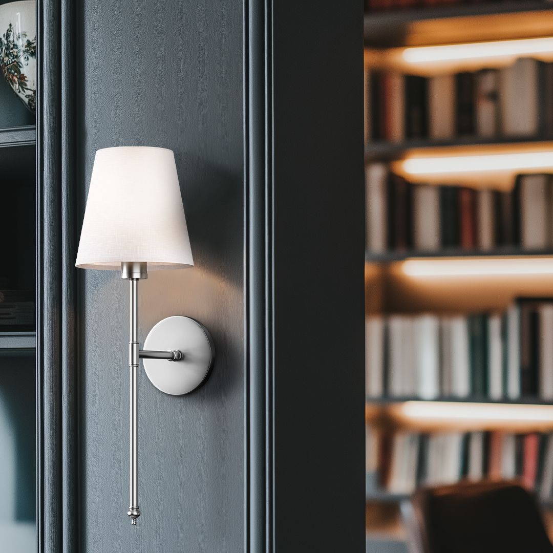 Wall-mounted sconce with white lampshade.