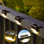 Black solar-powered led step light with sleek rectangular design and integrated sun sensor for outdoor garden use