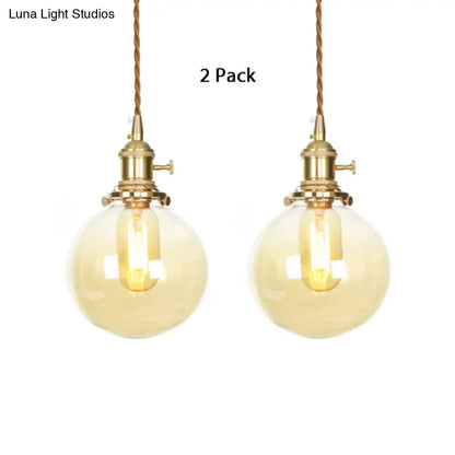 1-Light Amber Pendant Light with Adjustable Cord and Globe Glass Shade - Industrial Indoor Lighting