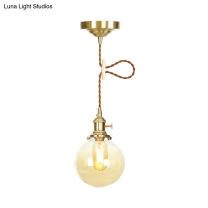 1-Light Amber Pendant Light with Adjustable Cord and Globe Glass Shade - Industrial Indoor Lighting