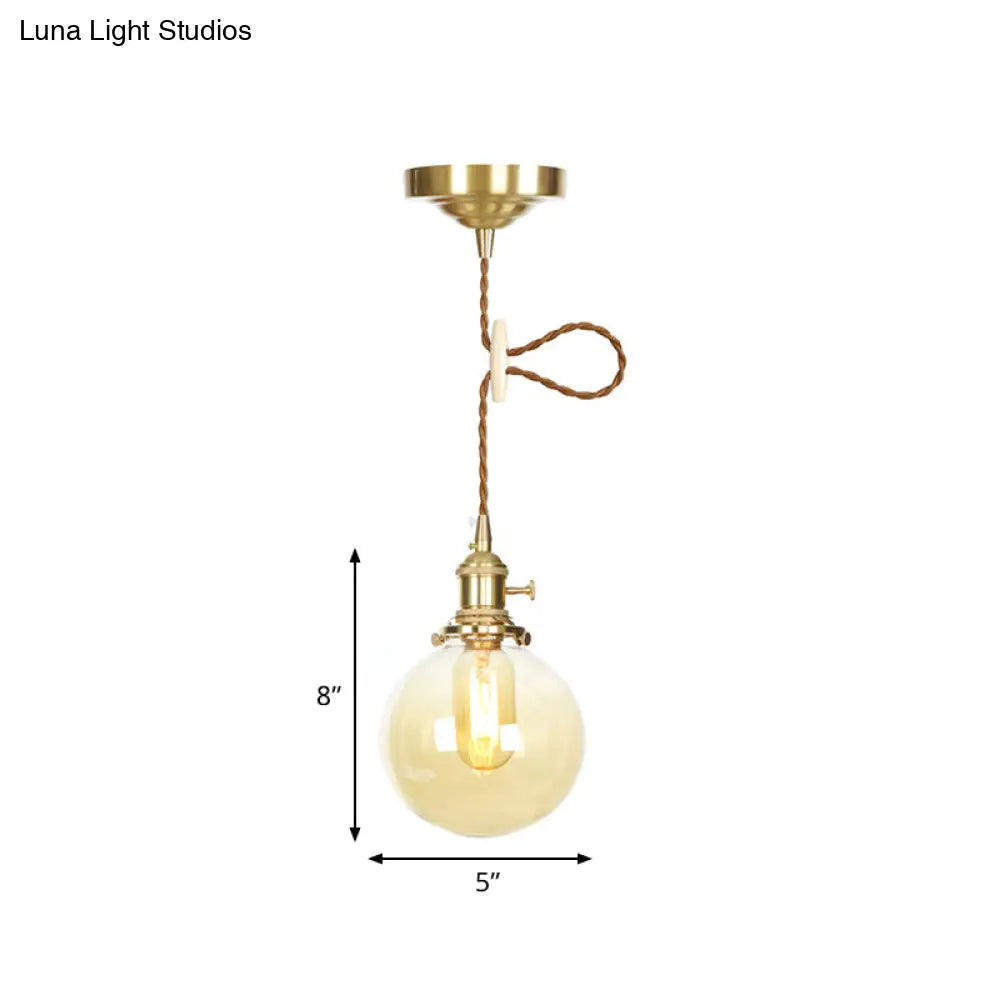 1-Light Amber Pendant Light with Adjustable Cord and Globe Glass Shade - Industrial Indoor Lighting