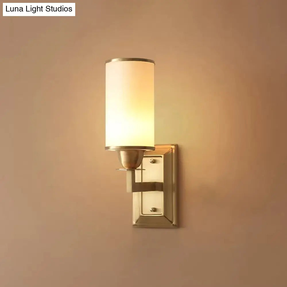 1-Light White Glass Wall Sconce in Traditional Brass - Elegant Cylindrical Dining Room Light