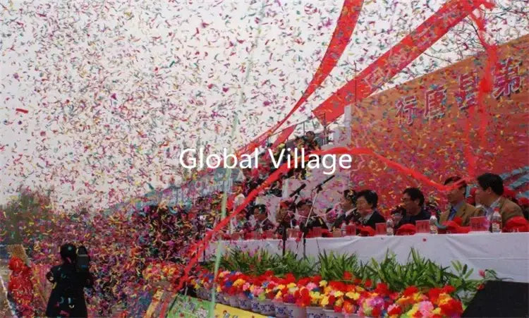 A vibrant red ribbon arches with colorful confetti falling from a 150w confetti machine wedding colorful cannon