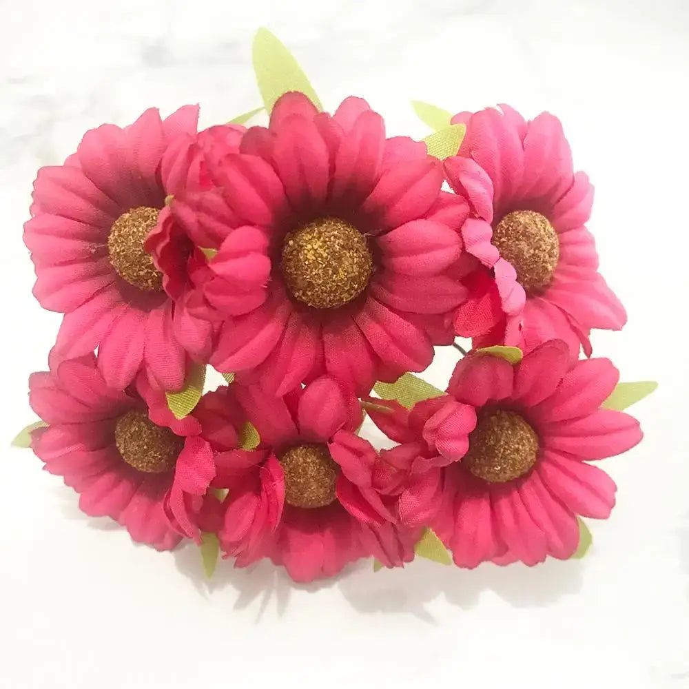 A cluster of vibrant pink mixed rose red artificial daisies with glittery gold centers and green fabric leaves for diy decor