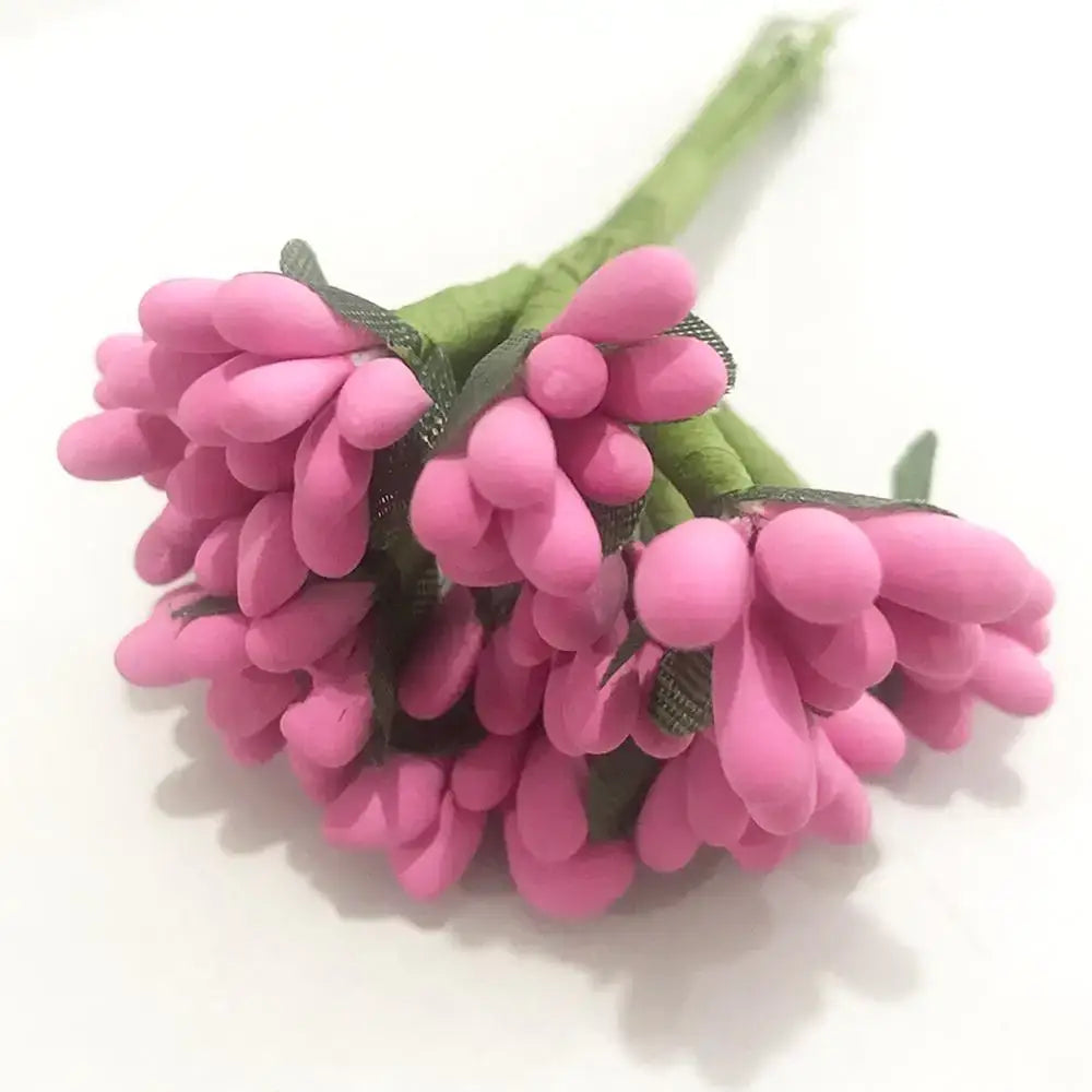 A cluster of vibrant pink artificial flowers with soft rounded petals and green stems in a 200pcs mixed rose red bundle
