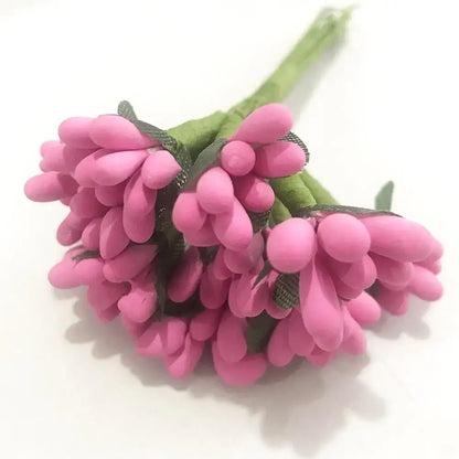 A cluster of vibrant pink artificial flowers with soft rounded petals and green stems in a 200pcs mixed rose red bundle