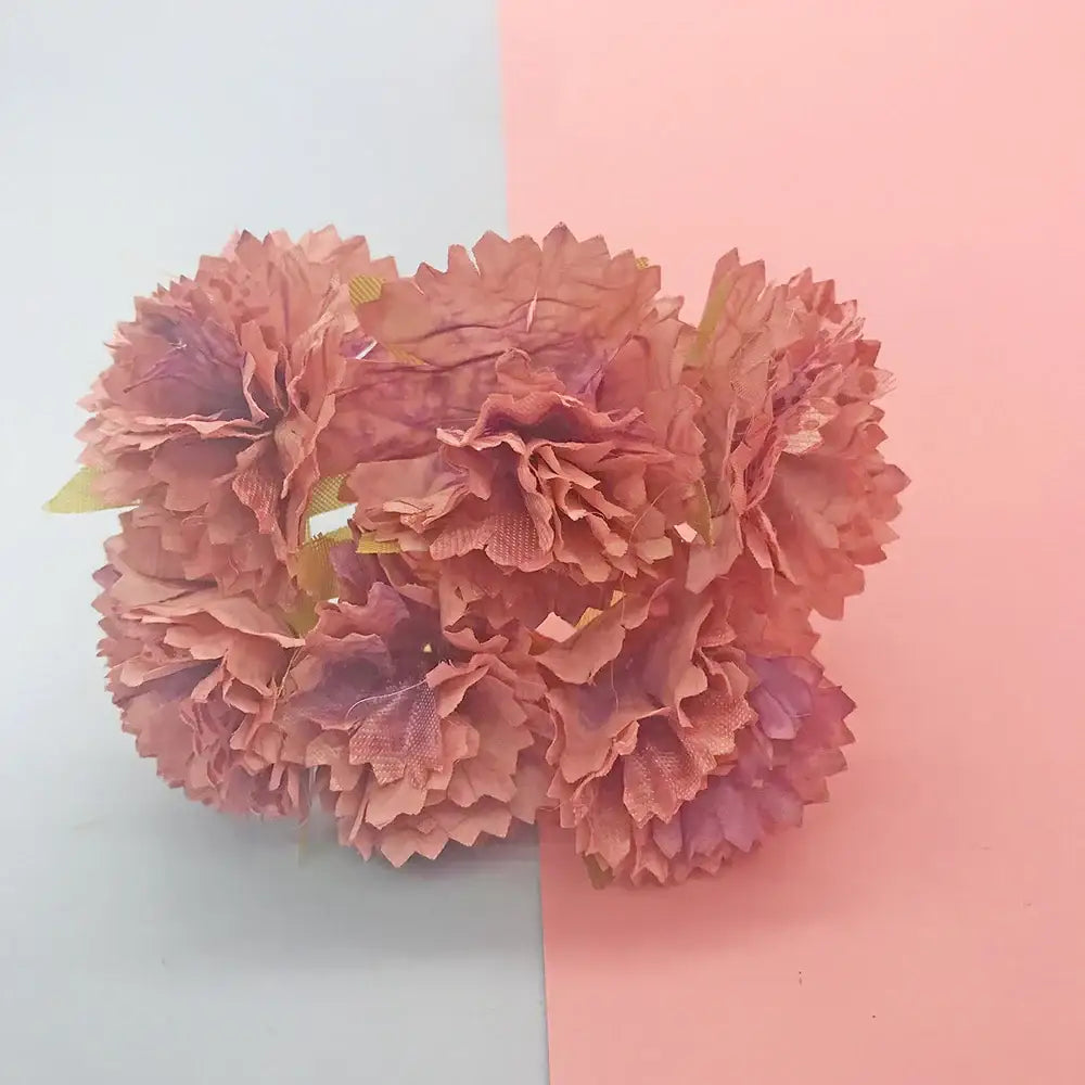 A cluster of artificial peach-colored carnations with layered petals in a 200pcs mixed rose red flower stamen bundle