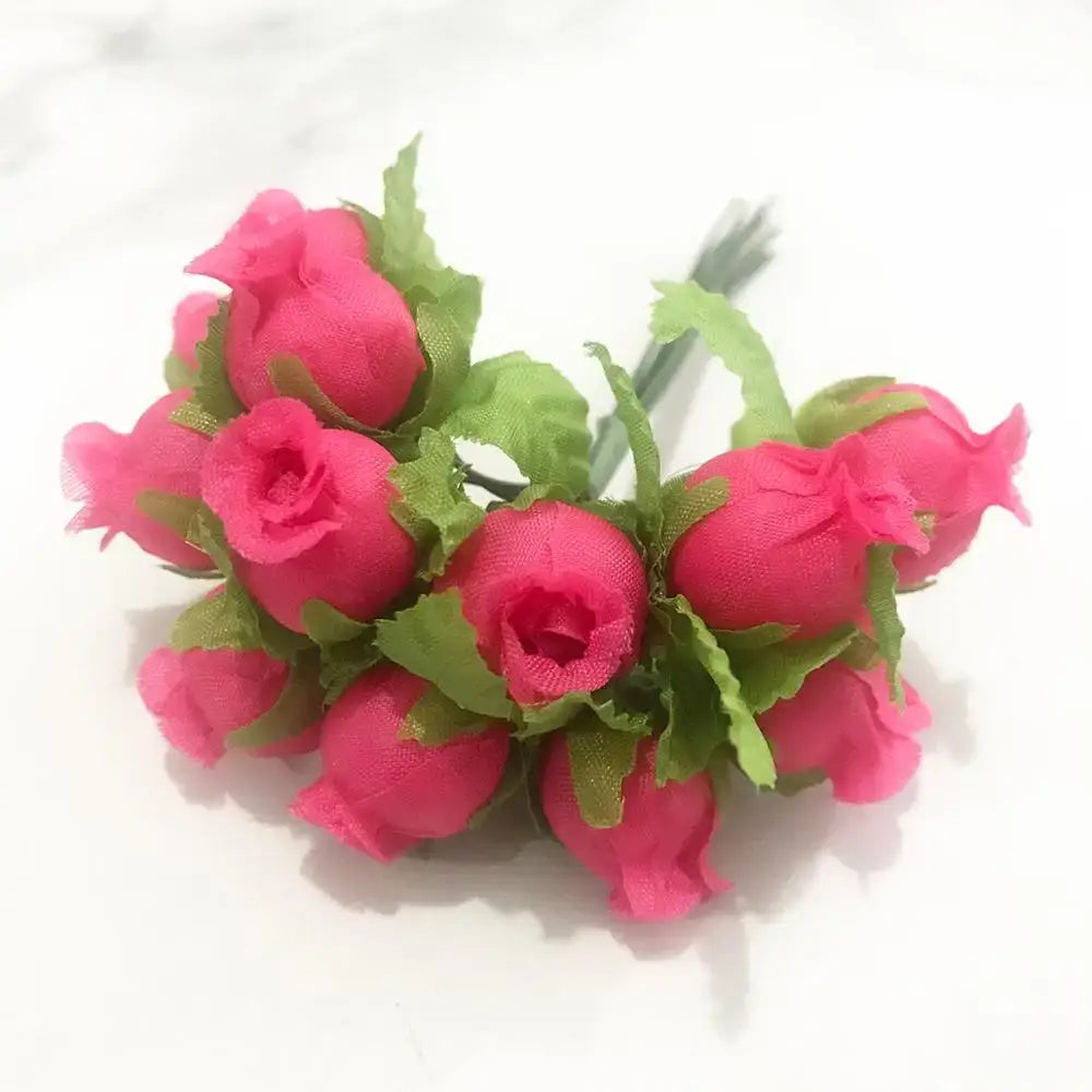 A cluster of vibrant pink fabric roses with green leaves in a 200pcs mixed rose red flower stamen bundle for diy decor