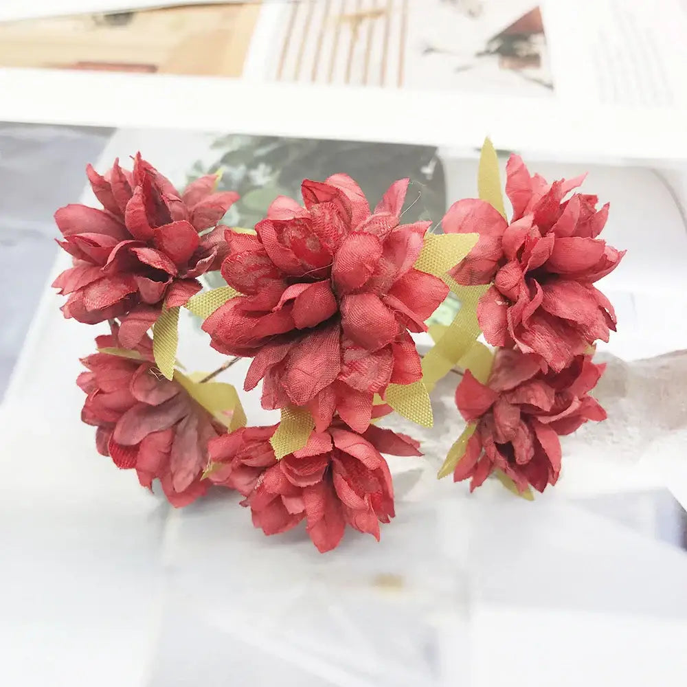 A cluster of 200pcs mixed rose red fabric flowers with yellow-green stems for bedroom diy decor crafted from textured material