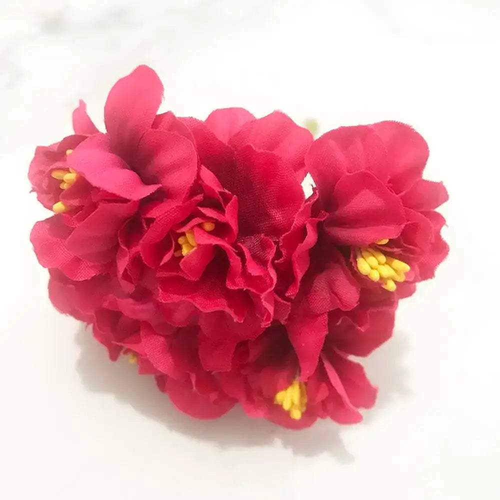 Vibrant rose red fabric flowers with yellow centers in a 200pcs mixed rose red flower stamen bundle for diy decor