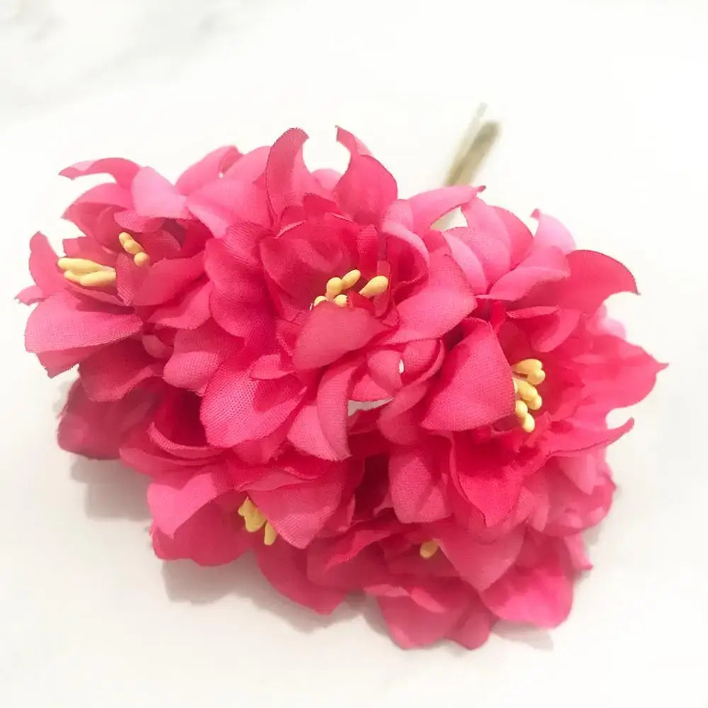 Vibrant 200pcs mixed rose red fabric flowers with yellow centers made from layered satin-like material for bedroom decor