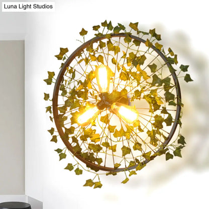 Aplique de pared estilo cabaña de metal negro con tres bombillas y decoración de hojas