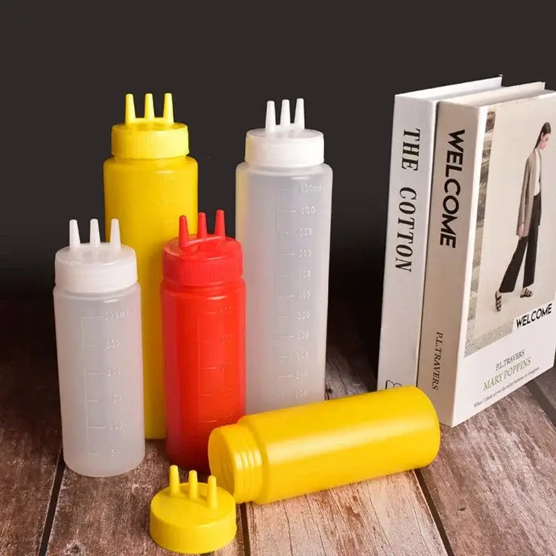 Set of colorful plastic squeeze bottle condiment dispensers with multi-spout caps in yellow red and clear varieties